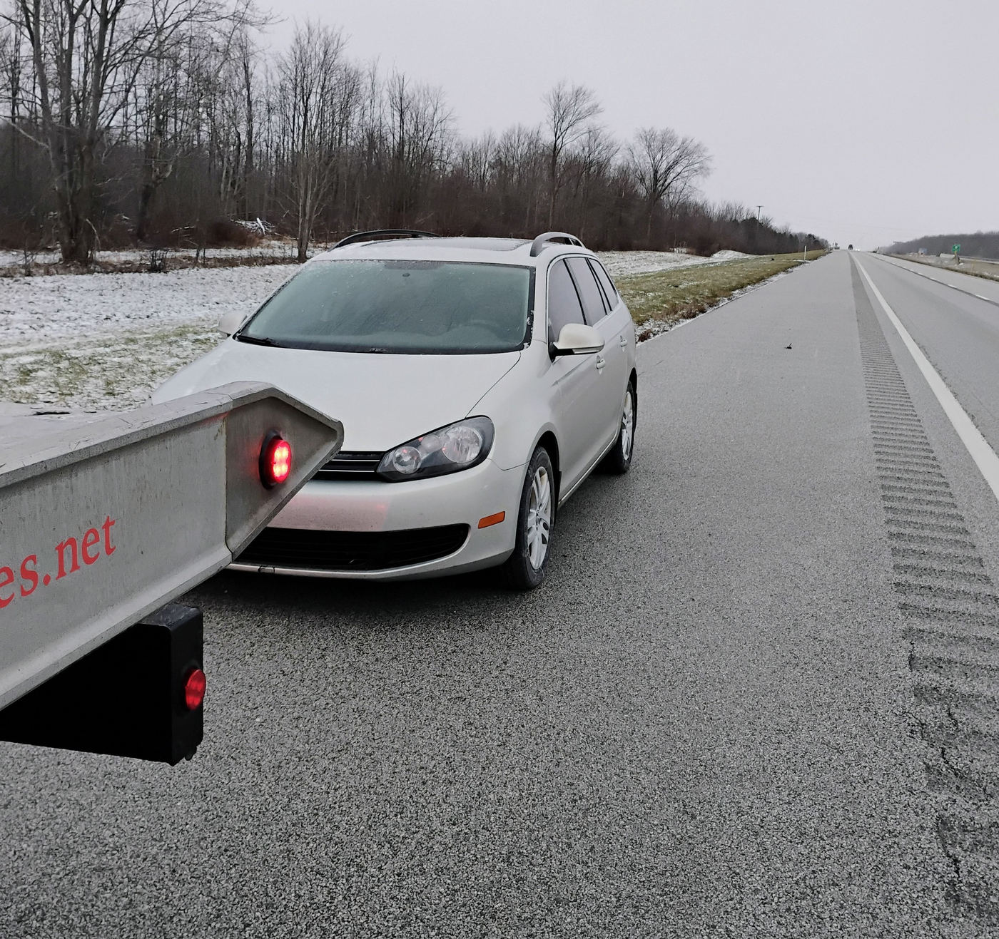 A car pulled over on the shoulder of a rural road